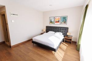 a bedroom with a bed with white sheets at TUNA OTEL in Gelibolu