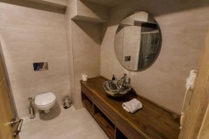 a bathroom with a sink and a toilet and a mirror at TUNA OTEL in Gelibolu