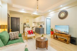 a living room with a couch and a flat screen tv at Kikao-Marina Bay in Nairobi +6 photos
