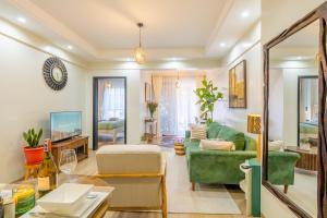a living room with a green couch and a table at Kikao-Marina Bay in Nairobi