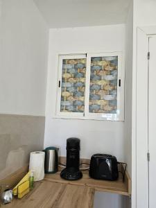 a kitchen counter with a toaster and a window at La Playa in Adeje