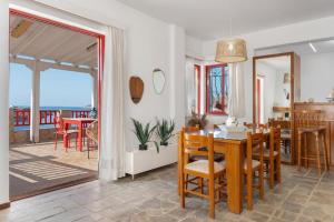 a dining room with a table and chairs and a balcony at Villa Christina 2 in Mérikhas