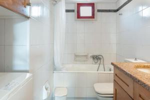 a bathroom with a tub and a toilet and a sink at Villa Christina 2 in Mérikhas +18 photos