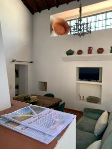 a living room with a couch and a table at Pisco Charming House - Alter Pedroso in Alter do Chão
