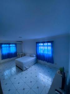 a large room with a bed and blue lights at PiscinasBar do Ramos in Conde