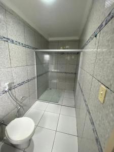 a white bathroom with a toilet and a shower at PiscinasBar do Ramos in Conde