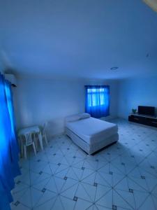 a bedroom with a bed and a blue light at PiscinasBar do Ramos in Conde