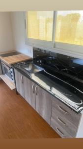 a kitchen with a stove and a sink at Quinta para alquilar in Junín
