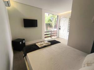 a bedroom with a bed with two towels on it at Gyn Suítes - Suítes novas e funcionais in Goiânia