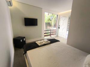 a bedroom with a bed with two towels on it at Gyn Suítes - Suítes novas e funcionais in Goiânia