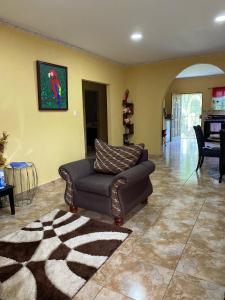 a living room with a couch and a rug at Royal Properties Link in Crooked Tree