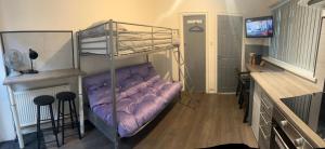 a room with a bunk bed and a desk at Townsend lane accommodation in Liverpool