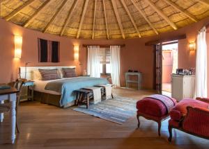 a bedroom with a bed and a wooden ceiling at Awasi Atacama in San Pedro de Atacama
