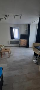 a large room with a table and a couch at Studio sans chambre 2 personnes in Arsac-en-Velay