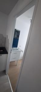 a view of a room with a sink and a mirror at Studio sans chambre 2 personnes in Arsac-en-Velay