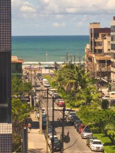 a city street with cars parked on the beach at Apto CAPAO DA CANOA Ed GABRIELA 6 Pers in Capão da Canoa