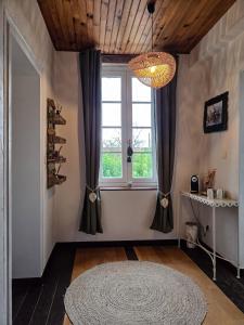 a living room with a large window and a rug at 3 chambres d'hôtes de charme avec jacuzzi & sauna au Clos de la Lèze in Lézat-sur-Lèze +34 photos