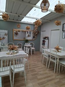 a dining room with white tables and white chairs at Pueblito Boyacense Hotel in Duitama