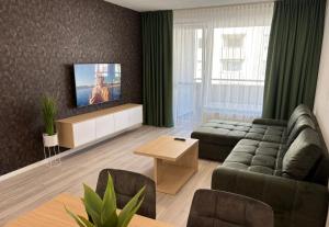 a living room with a couch and a tv at home&stay - free parking in Trenčín