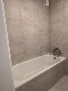 a bathroom with a white bath tub in a room at home&stay - free parking in Trenčín +20 photos