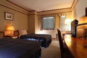 Ένα ή περισσότερα κρεβάτια σε δωμάτιο στο Hotel Viamare Kobe