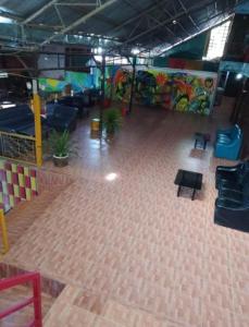 an empty room with tables and chairs and a mural at Reggaein in Phi Phi Islands