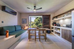 a living room with a green couch and a table at Condominios Punta Morelos in Brisas de Zicatela