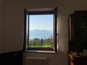 a window with a view of a mountain at Casa Vacanze a Luino - Casa di Adele in Luino