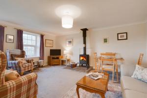 a living room with a couch and a fireplace at 2 Bed in Askrigg oc-ds1019 in Askrigg