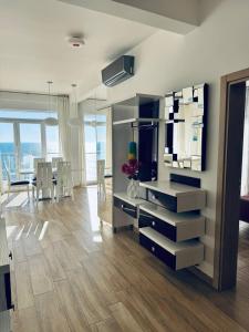 a living room with a television and a dining room at SF Apartments Lux in Dobra Voda