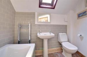 a bathroom with a sink and a toilet and a tub at 2 Bed in Bodham oc-1660 in Bodham +6 photos