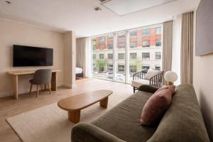 a living room with a couch and a large window at Nester Finn Entertainment District in Toronto +43 photos