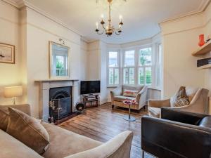 a living room with a fireplace and a chandelier at 5 Bed in Swanage oc-dc060 in Swanage