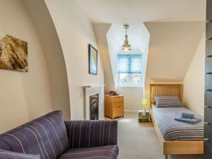 a living room with a bed and a couch at 5 Bed in Swanage oc-dc060 in Swanage