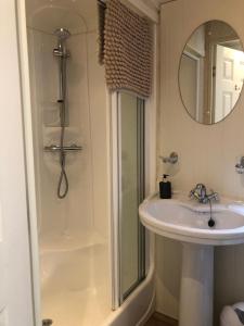 a bathroom with a sink and a shower at 29 The Beeches in Gilcrux +20 photos