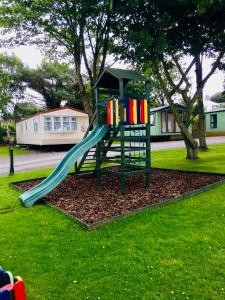 a playground with a slide in a yard at 29 The Beeches in Gilcrux