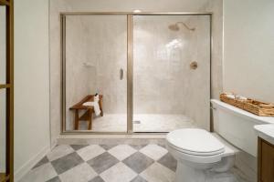 a bathroom with a glass shower with a toilet at Luxury Rooftop Pool & Dock Steps to Downtown in Annapolis