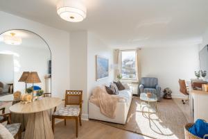 a living room with a couch and a table at Luxury Rooftop Pool & Dock Steps to Downtown in Annapolis +44 photos