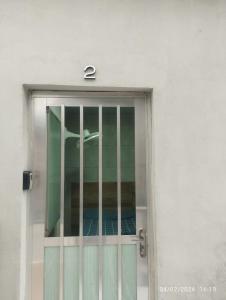 a door with ajar glass with a number on it at Suíte 2 Itaguaí in Itaguaí +4 photos