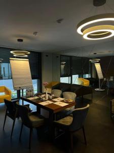 a dining room with a wooden table and chairs at Intergroup Business & Design Hotel Ingolstadt in Kösching