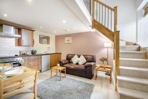 a living room with a couch and a staircase at 1 Bed in Berwick-upon-Tweed oc-a32026 in Kyloe