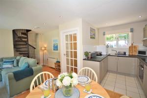 a kitchen and living room with a table and chairs at 2 Bed in Little Petherick oc-p00635 in Little Petherick