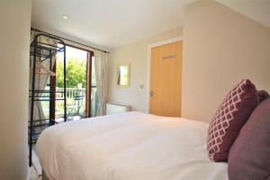 a bedroom with a white bed and a window at 2 Bed in Little Petherick oc-p00635 in Little Petherick