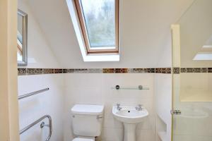 a bathroom with a toilet and a sink and a window at 2 Bed in Little Petherick oc-p00635 in Little Petherick +15 photos