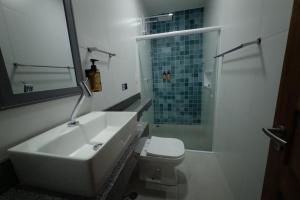 a bathroom with a sink and a shower and a toilet at A Flor Pousada in Garanhuns +32 photos