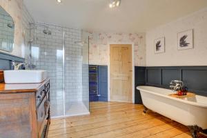 a large bathroom with a tub and a sink at 6 Bed in Cromer oc-1996 in Cromer +24 photos
