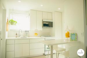 a kitchen with white cabinets and a white table at Gulfside Resort. Unit 10 in St. Pete Beach +24 photos