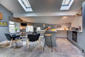 a kitchen with gray cabinets and bar stools at 2 Bed in Hawes oc-ds937 in Hawes
