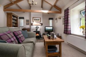 a living room with a couch and a fireplace at 2 Bed in Low Row oc-ds1010 in Gunnerside
