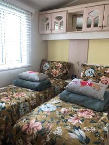 a living room with two beds and a couch at 29 The Beeches in Gilcrux